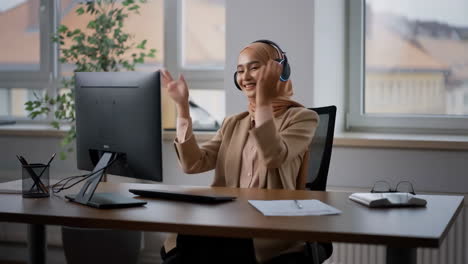 young muslim woman on a video call in the office