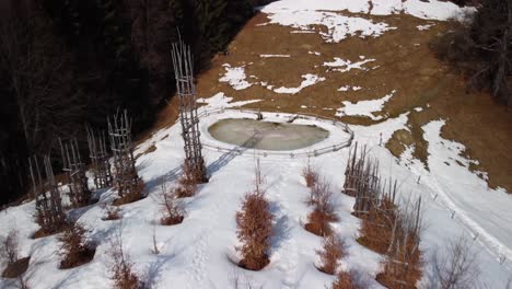 Aerial-Flying-Over-Snow-Covered-Tree-Cathedral-On-Hillside-Located-Near-Pizzo-Arera