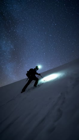 night ascent on a snowy mountain under a starry sky