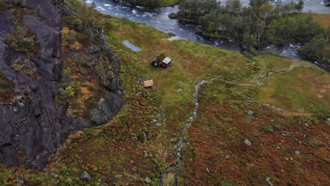 dramatic aerial of rugged cabin in the mountains of norway