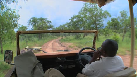 point of view of a driver driving on a dirt road in africa