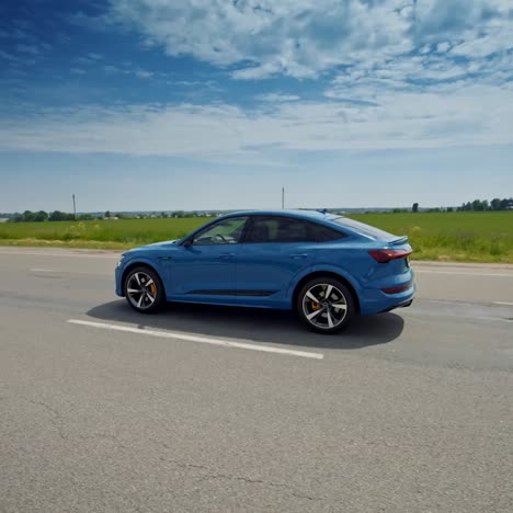audi e-tron driving on road. electric compact luxury crossover suv produced by audi