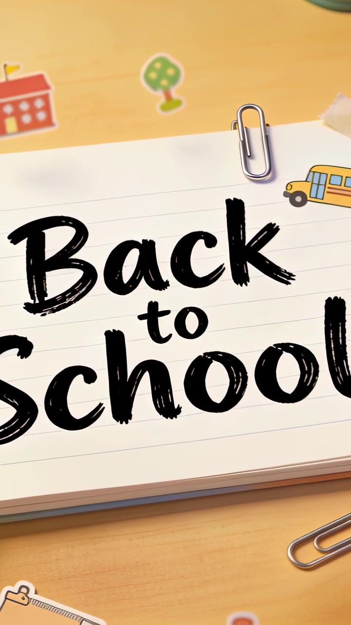 Vertical video: Showing lined page Back-to-School on desk, camera panning to show clips, decals