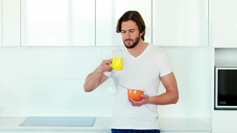 Man-having-breakfast-in-kitchen