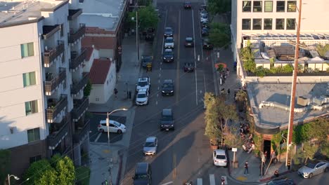 aerial view of arts district, downtown los angeles usa, street traffic and buildings at sunset, pull back drone shot