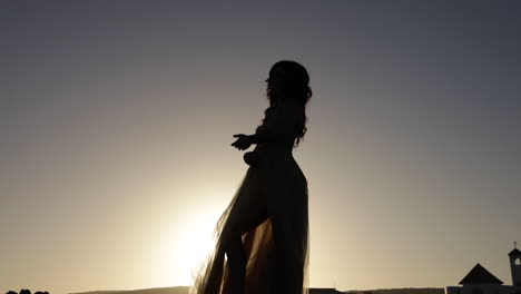 silhouette of girl dancing in sunset