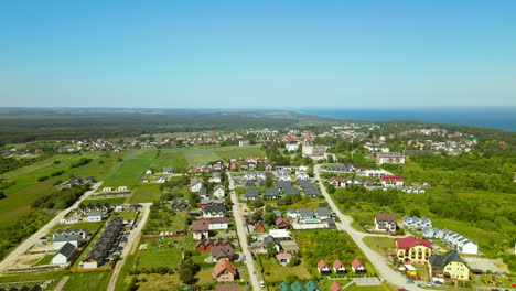 rural town in northern poland on clear summer day, aerial