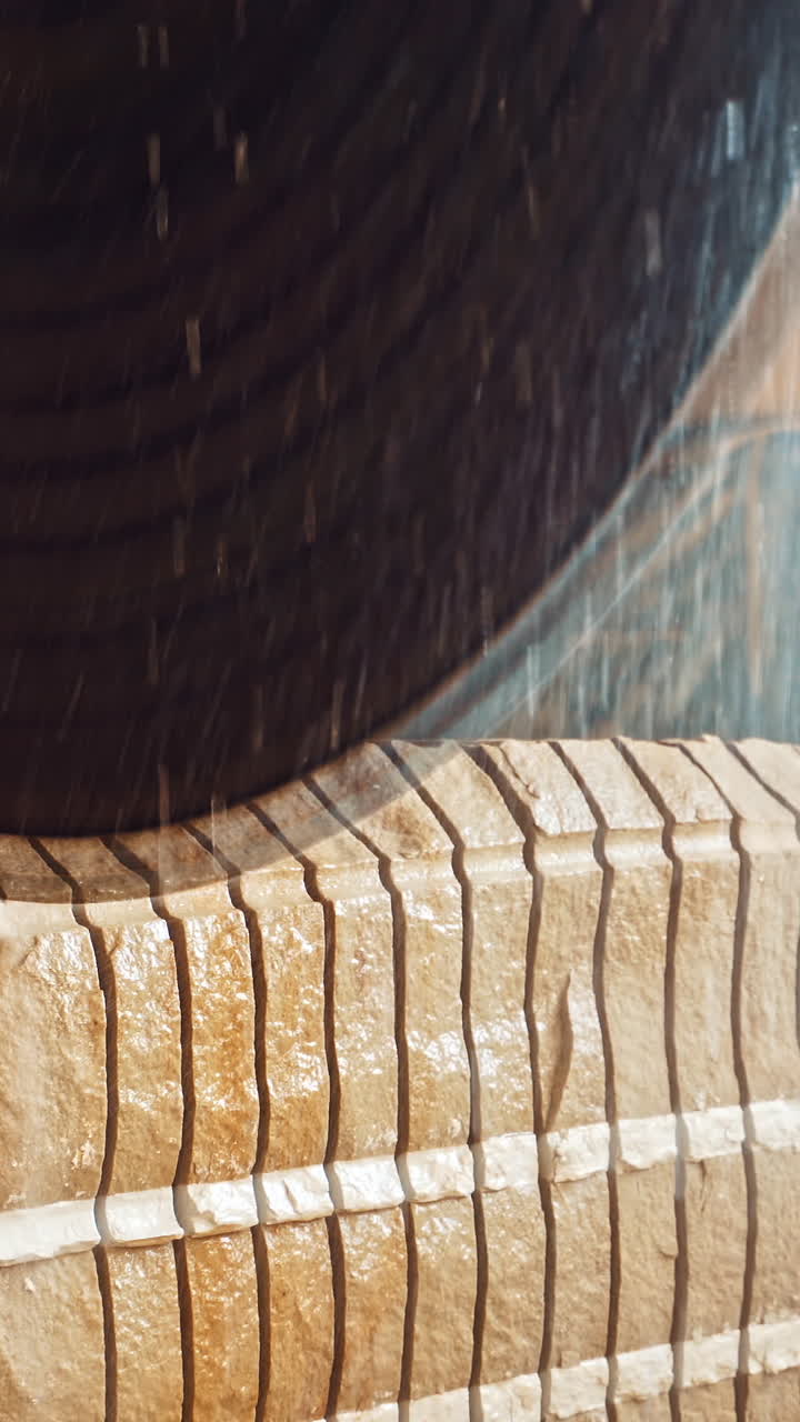 Circular saw for cutting. Close up of worker use wet sawing machine for cutting marble stone Vertical video