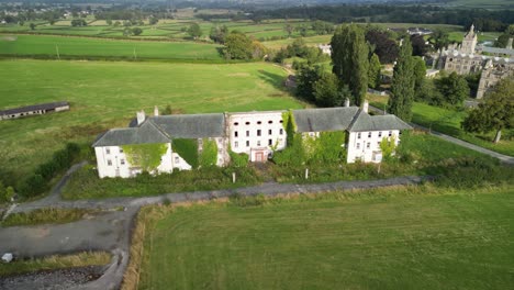 haunted denbigh lunatic asylum, north wales, nurses quarters, aerial anticlockwise rotate and move over, sunny afternoon