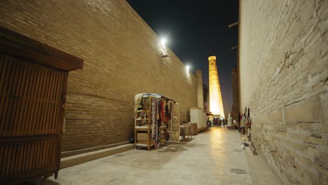 khiva minaret merchants' stalls on the street of the ancient city in the evening. ichan kala fortress uzbekistan