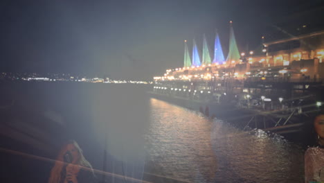 two women singing duet at night waterfront using microphones, animated dual-exposure technology