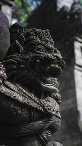 Ancient lion statues in Bali island near temple, close up vertical view