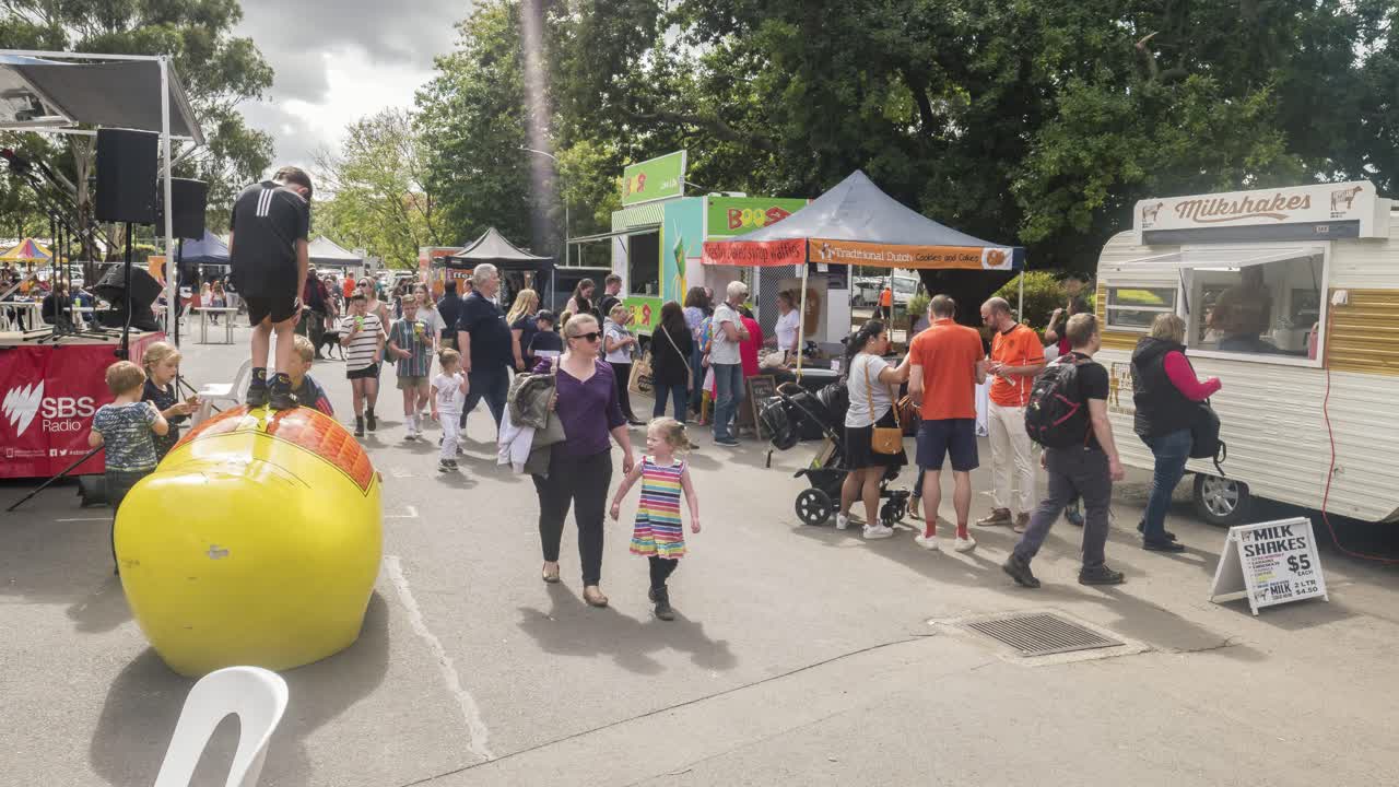 Timelapse of people with giant yellow clogs at the Holland Festival in the outer suburbs of Melbourne, Victoria, Australia, March 2020.