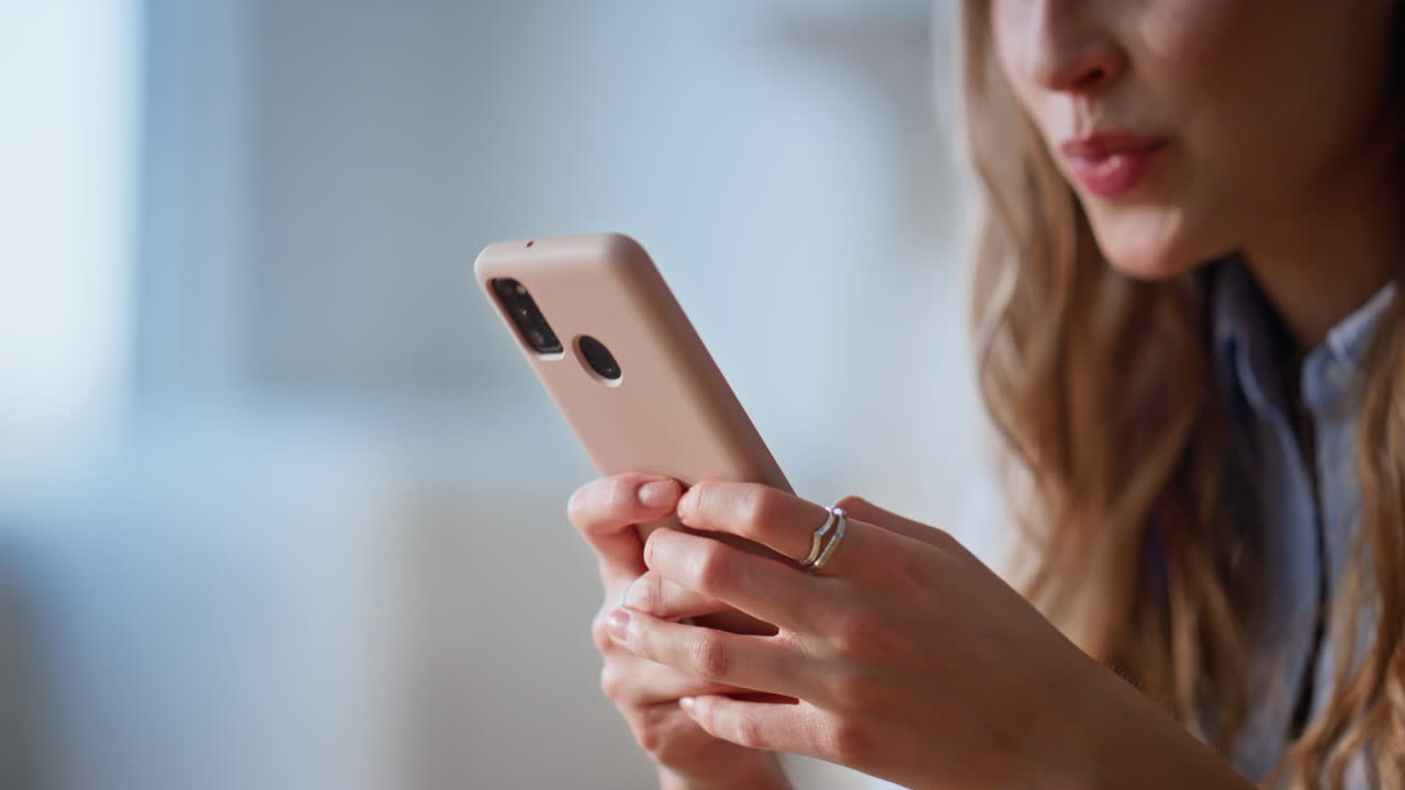 Housewife hands messaging cellphone in kitchen domestic weekend morning closeup