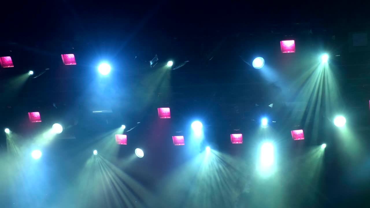 공연 중에 콘서트 무대에서 4k uhd 휴대용 조명 장비, 스포트라이트에서 을 통해 빛의 광선, 파란색과 노란색, 보라색, 초록색 빛의 빛.