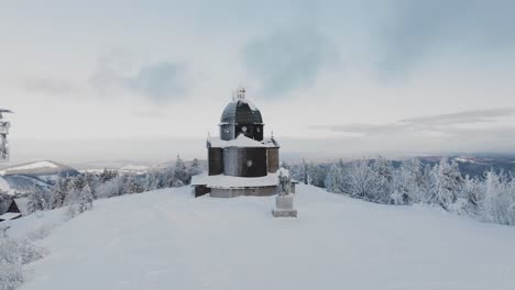 slow approach to the frozen radhost chappel during a morning golden hour in winter, beskydy 4k