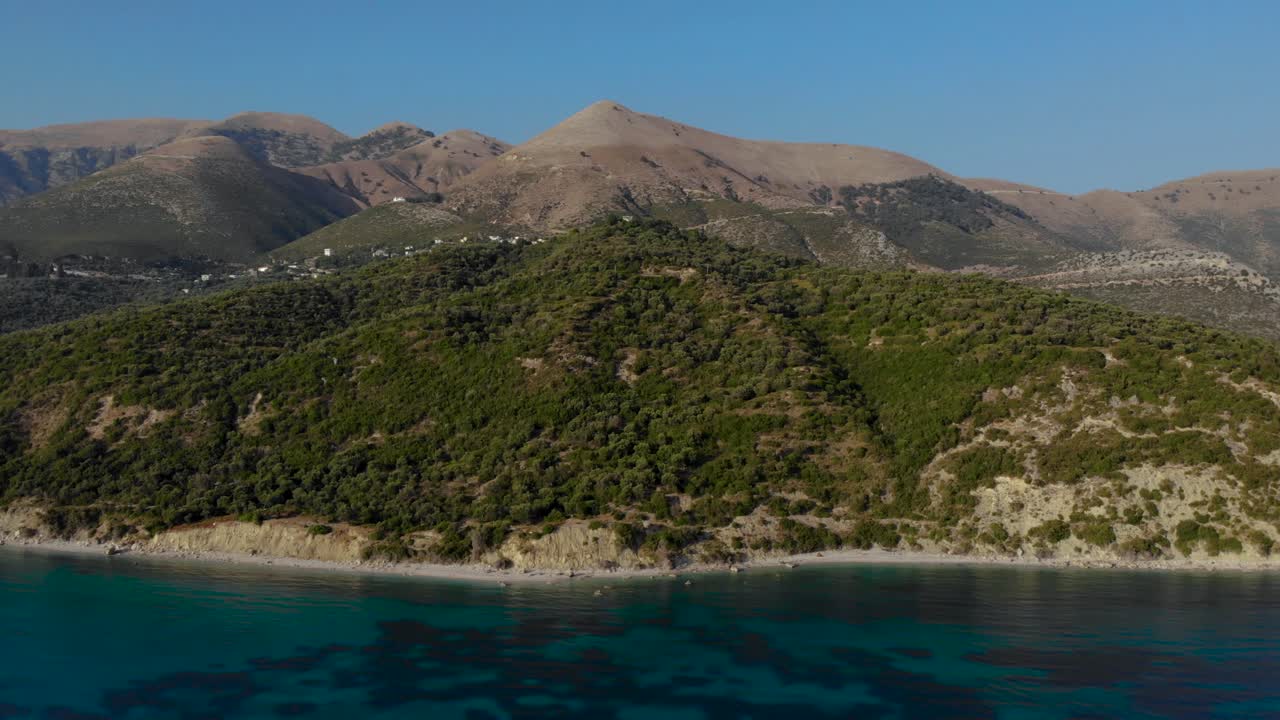Mediterranean coastline with hills and mountains surrounded by turquoise sea on summer