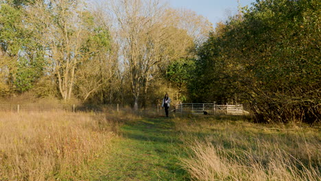 an asian woman running with her dog