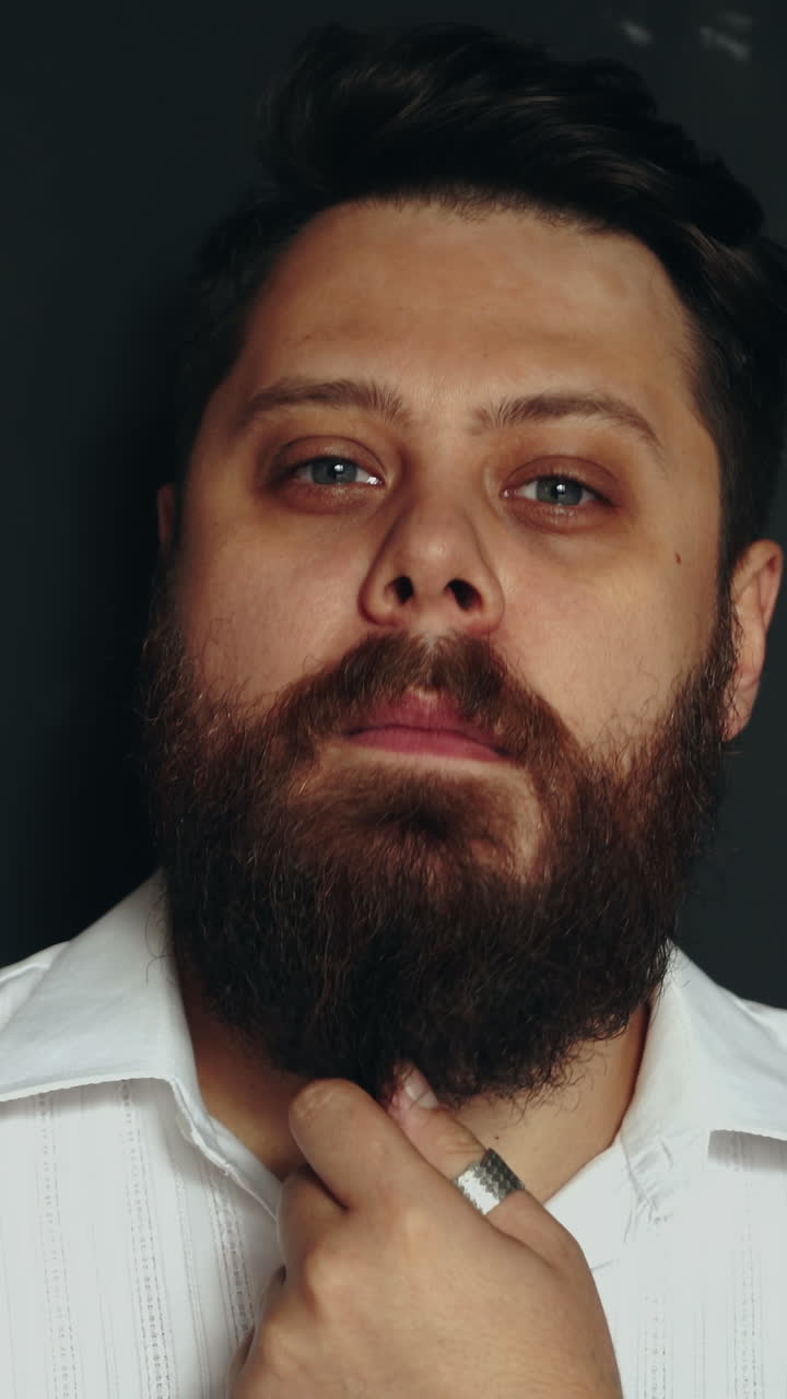 Gentleman posing in studio. Portrait of stylish handsome man with beard in studio Vertical video