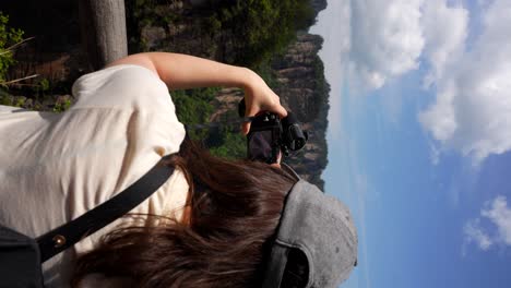 woman films the stunning karst pillars of yuanjiajie in zhangjiajie on a clear day, china