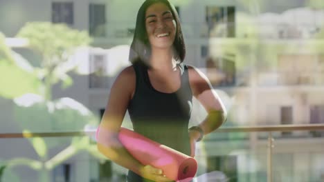 Animation-of-glowing-lights-over-biracial-woman-with-yoga-mat