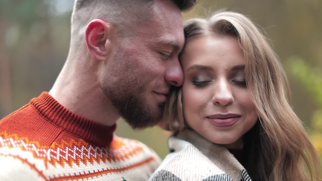 Enamored pair enjoying each other's company during the date. Man and woman having rendezvous at the natural background of countryside.