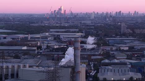 enfield power station complex smoking exhaust aerial view with london city purple dusk skyline