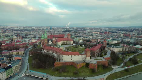 aerial stablishing shot moving upwards revealing the city of krakow, poland, with the wawel royal castle and the city center in the background