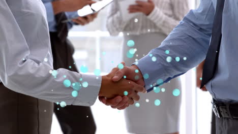 side view of businessmen shaking hands with sparkling blue light bubbles in foreground