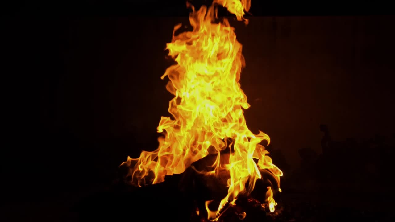 A closeup shot of Fire Burning outside at night isolated on black background