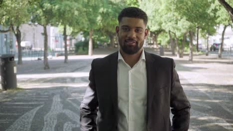 Confident-bearded-businessman-posing-with-crossed-arms.