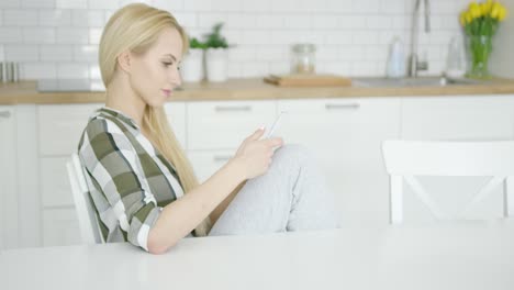 Woman-using-phone-at-home