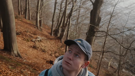 young man turning around and looking up thoughtfully