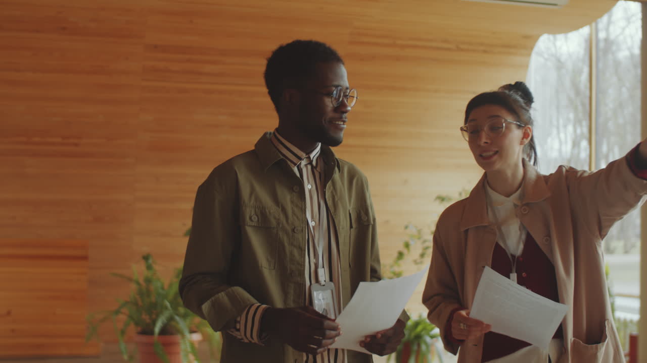 Diverse Library Workers Speaking in Auditorium