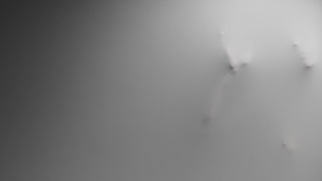 A creepy silhouette of a woman appears from the white surface