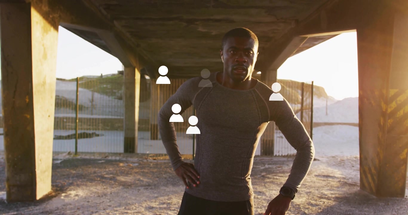 Man monitoring sports watch under concrete overpass at beach, showing animated heart rate charts