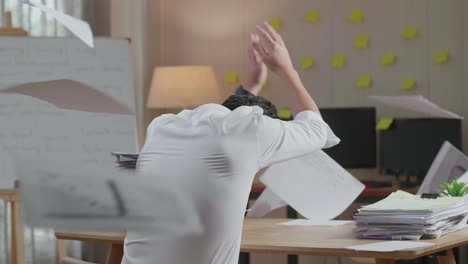 back view of pressure asian man throw away the paper while working hard with documents at the office