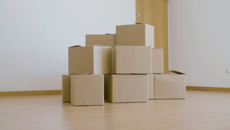 stack of cardboard boxes for moving in empty house