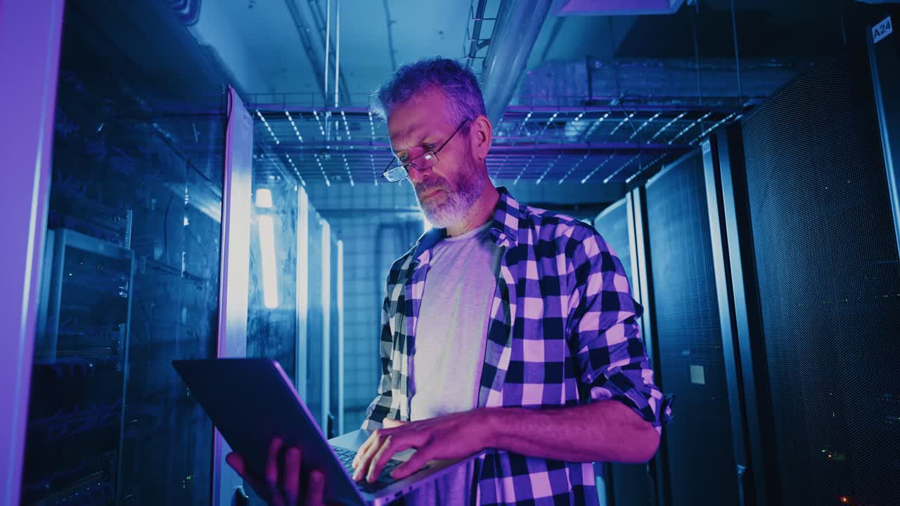 Technician Working in a Data Center at Night