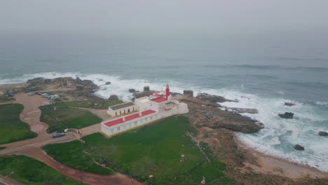 red beacon placed coast under grey morning sky aerial view. endless sea beauty