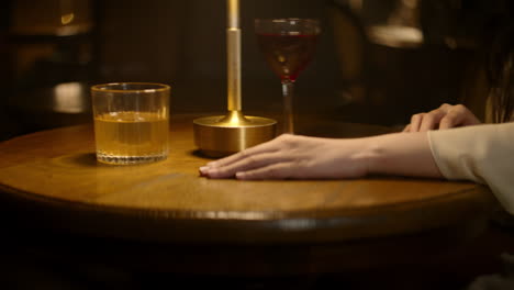 a woman removes her wedding ring, sliding it across a table and leaving it behind