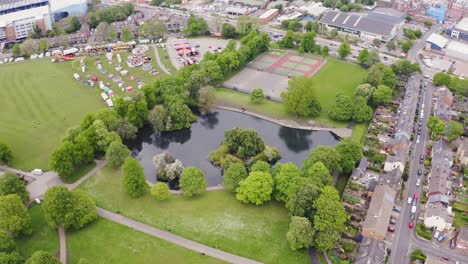 aerial shot flying over a lake and trees in the beautiful english countryside