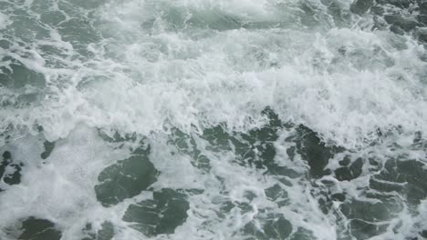 Cinematic-slow-motion-wave-in-dark-green-waters