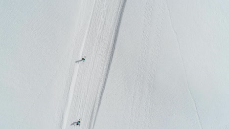 aerial top down showing group of friends cross country skiing in jura mountains ,france - valley combe a la chèvre