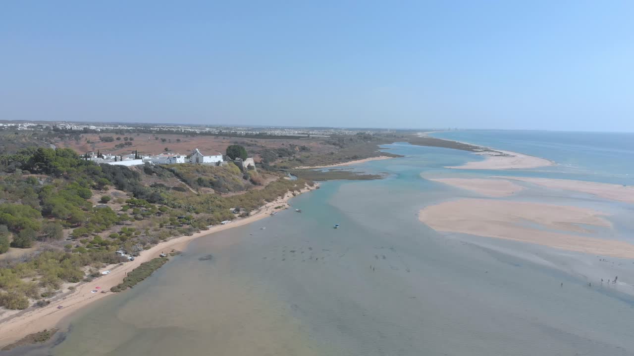 Aerial view of small village surrounded by beautiful bay where the river flows into the ocean