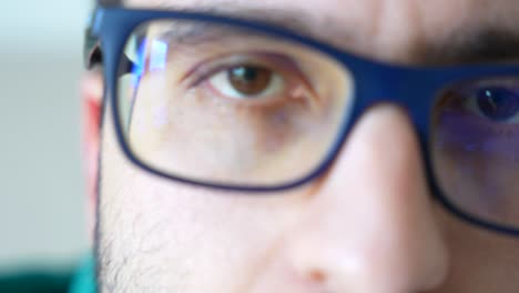 extreme close up panning shot of white man eyes with glasses