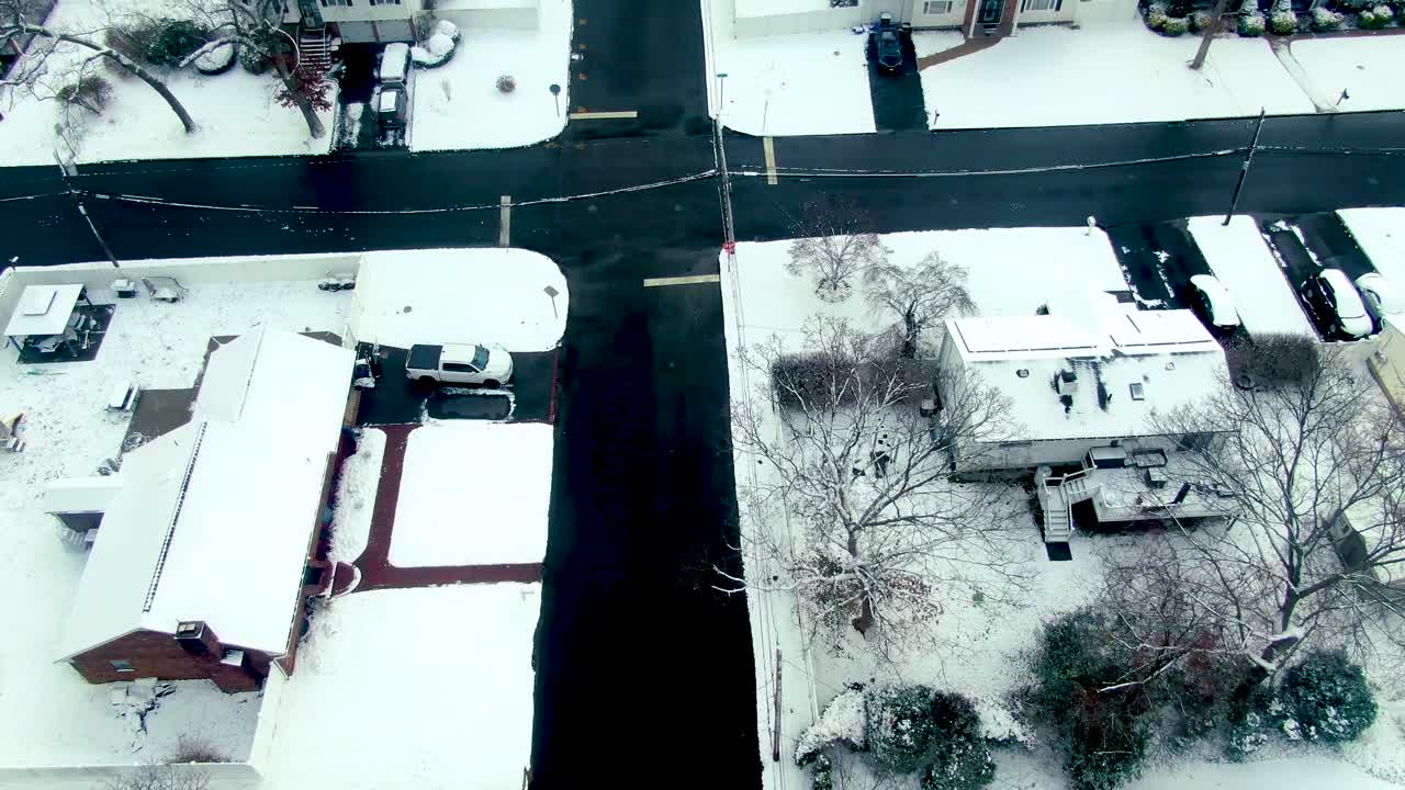 United States houses neighbourhood winter snow covered middle income, aerial drone