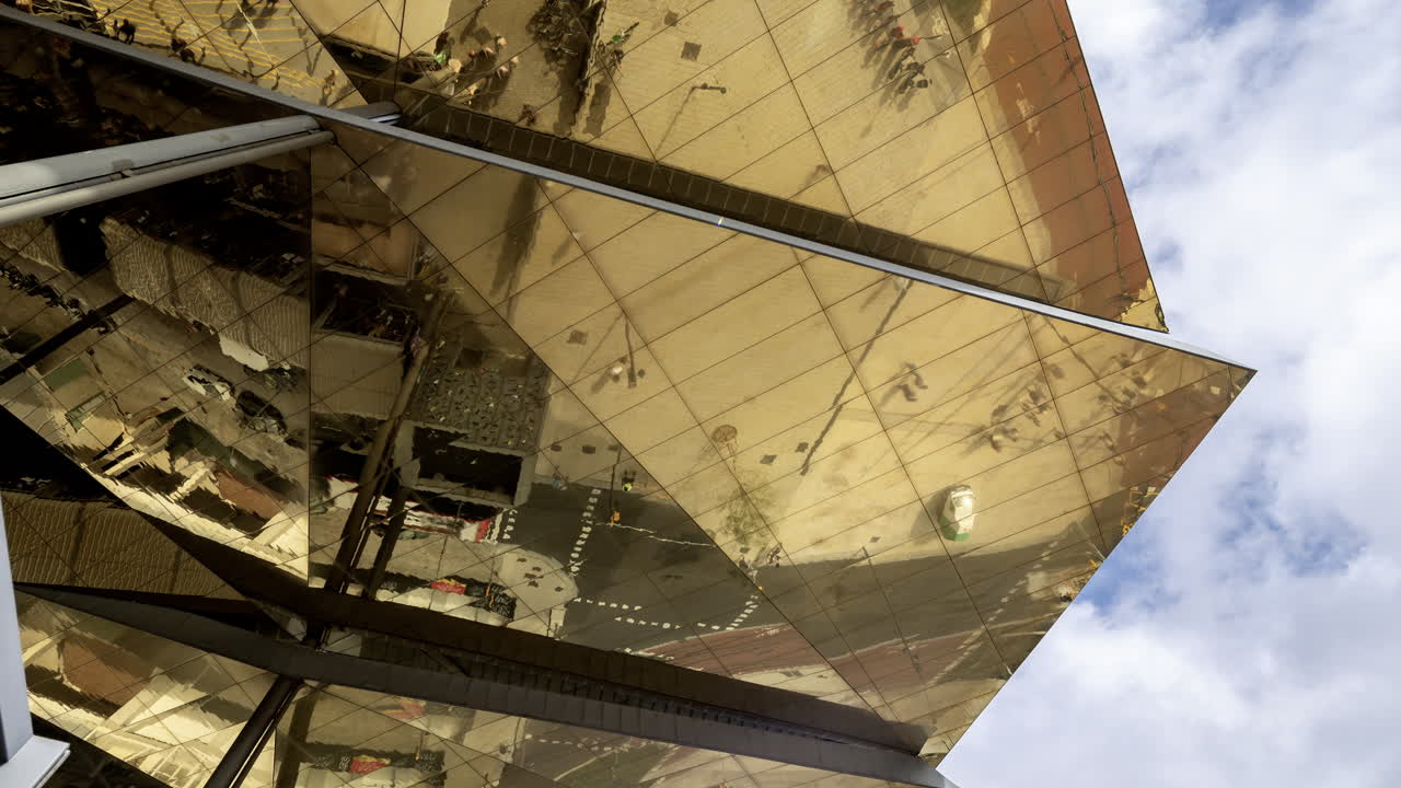Timelapse of the encants second hand market with gloden reflecting roof in barcelona