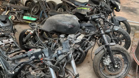 old and disused motorcycles stand in a row in a motorcycle graveyard