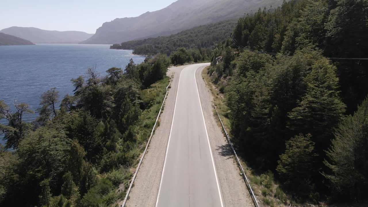 Aerial view over highway coastline in Lake Nahuel Huapi, Bariloche, Argentina, forest and mountain range